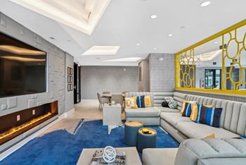 A living room with couches and a television and a fireplace